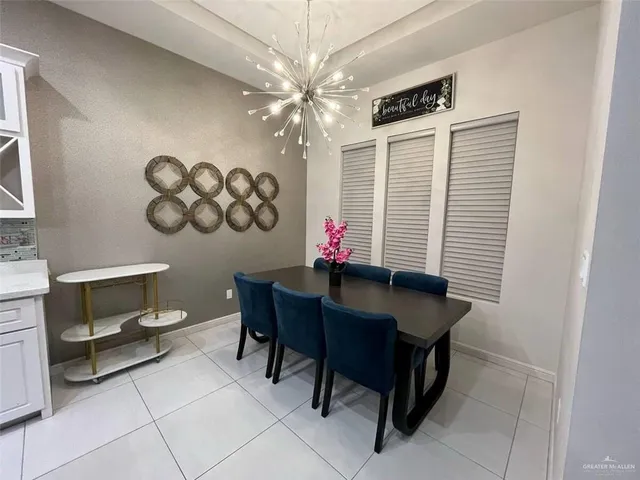 a view of a dining room with furniture and chandelier