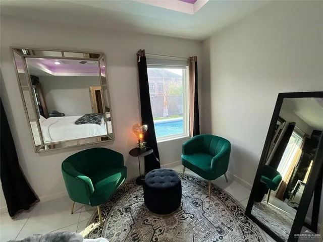 a bedroom with a bed a large window and flat screen tv