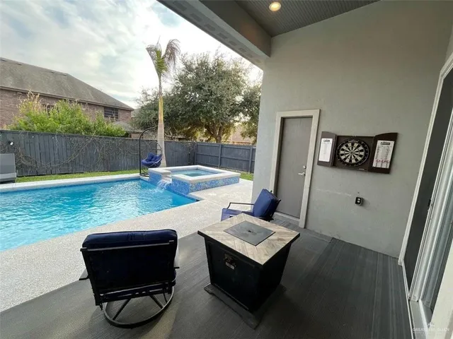 a backyard of a house with table and chairs