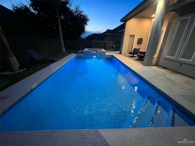 a view of a house with backyard porch and sitting area