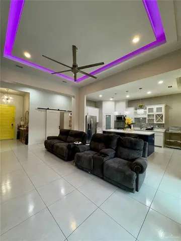 a living room with furniture and kitchen view