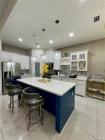 a kitchen with a sink stainless steel appliances and cabinets