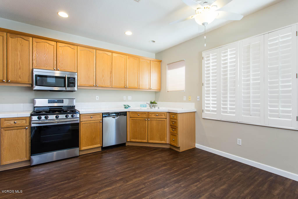 74 Bending Branch Way Simi Valley, CA 93065 - Photo 24 of 41 a kitchen with stainless steel appliances granite countertop a stove a sink and a microwave