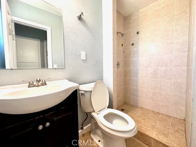 a bathroom with a sink toilet and a mirror