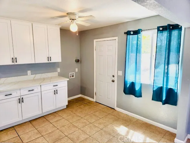 a spacious bathroom with a granite countertop sink and a mirror