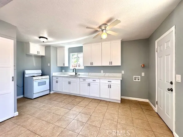 a large kitchen with a stove a sink dishwasher and a refrigerator