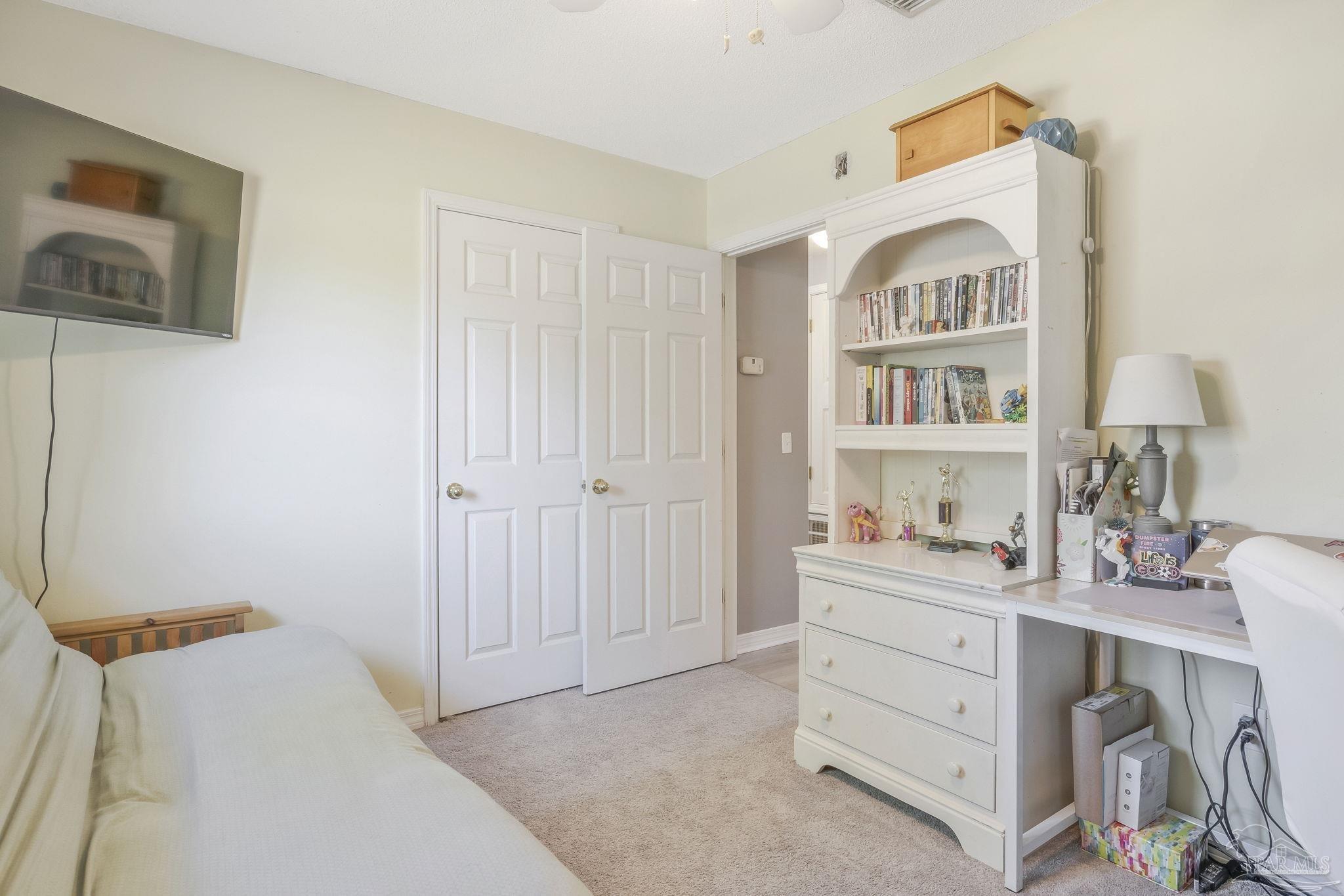 5539 Windrun Place Pace, FL 32571 - Photo 23 of 62 a view of a bedroom with a bed and a window