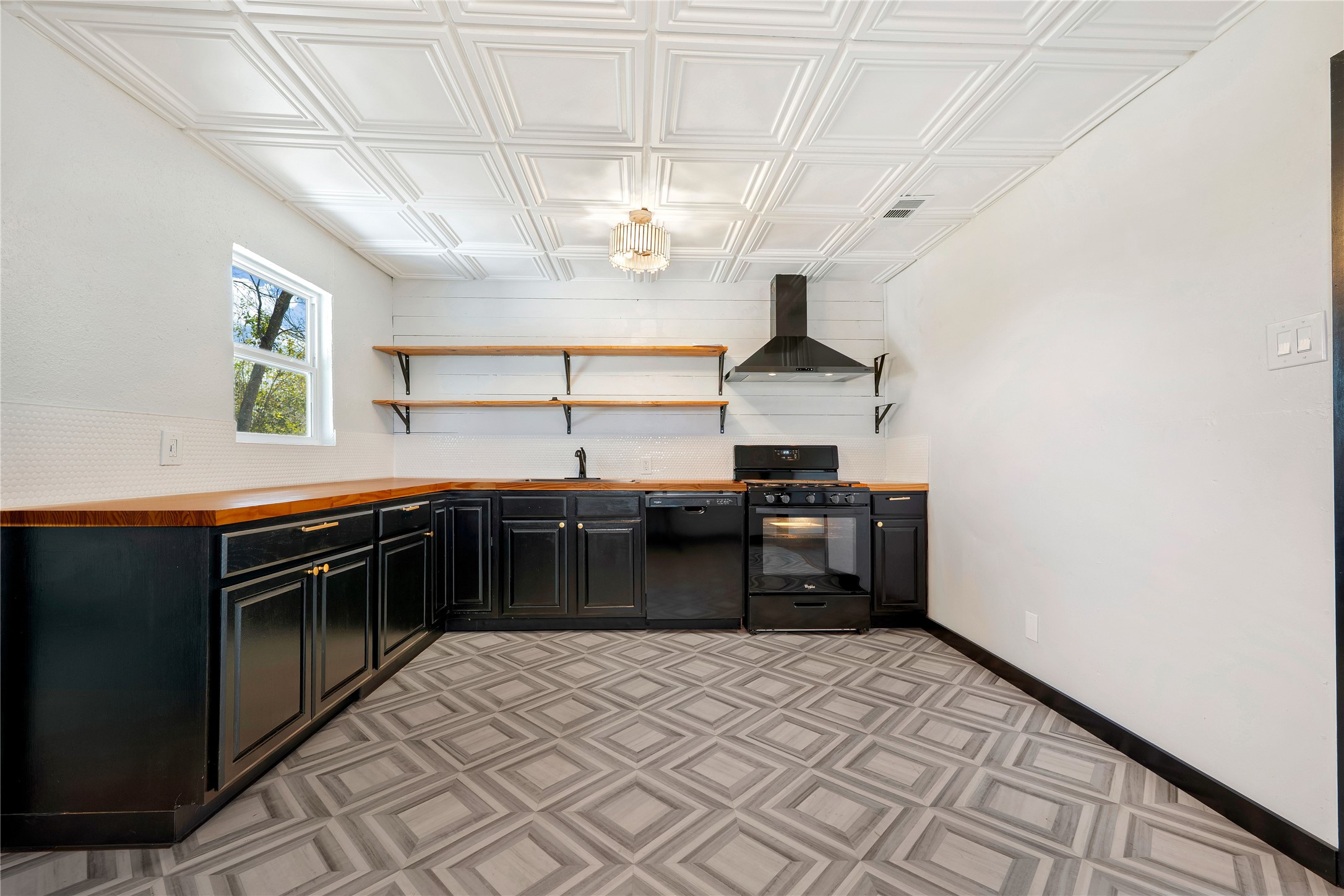 6915 Providence Avenue Austin, TX 78752 - Photo 11 of 27 a kitchen with stainless steel appliances a stove and a refrigerator