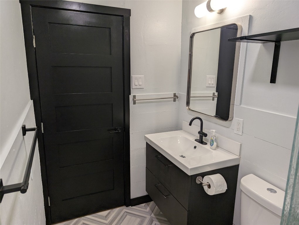 6915 Providence Avenue Austin, TX 78752 - Photo 12 of 27 Bathroom with vanity and vinyl flooring
