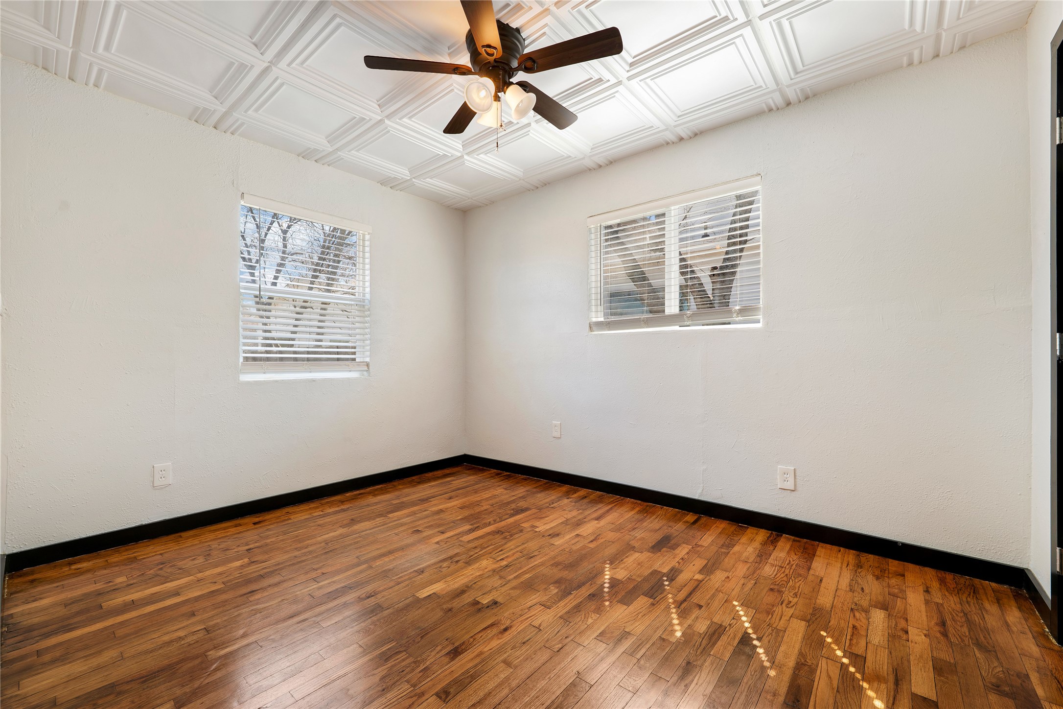 6915 Providence Avenue Austin, TX 78752 - Photo 15 of 27 a view of an empty room with wooden floor and a window