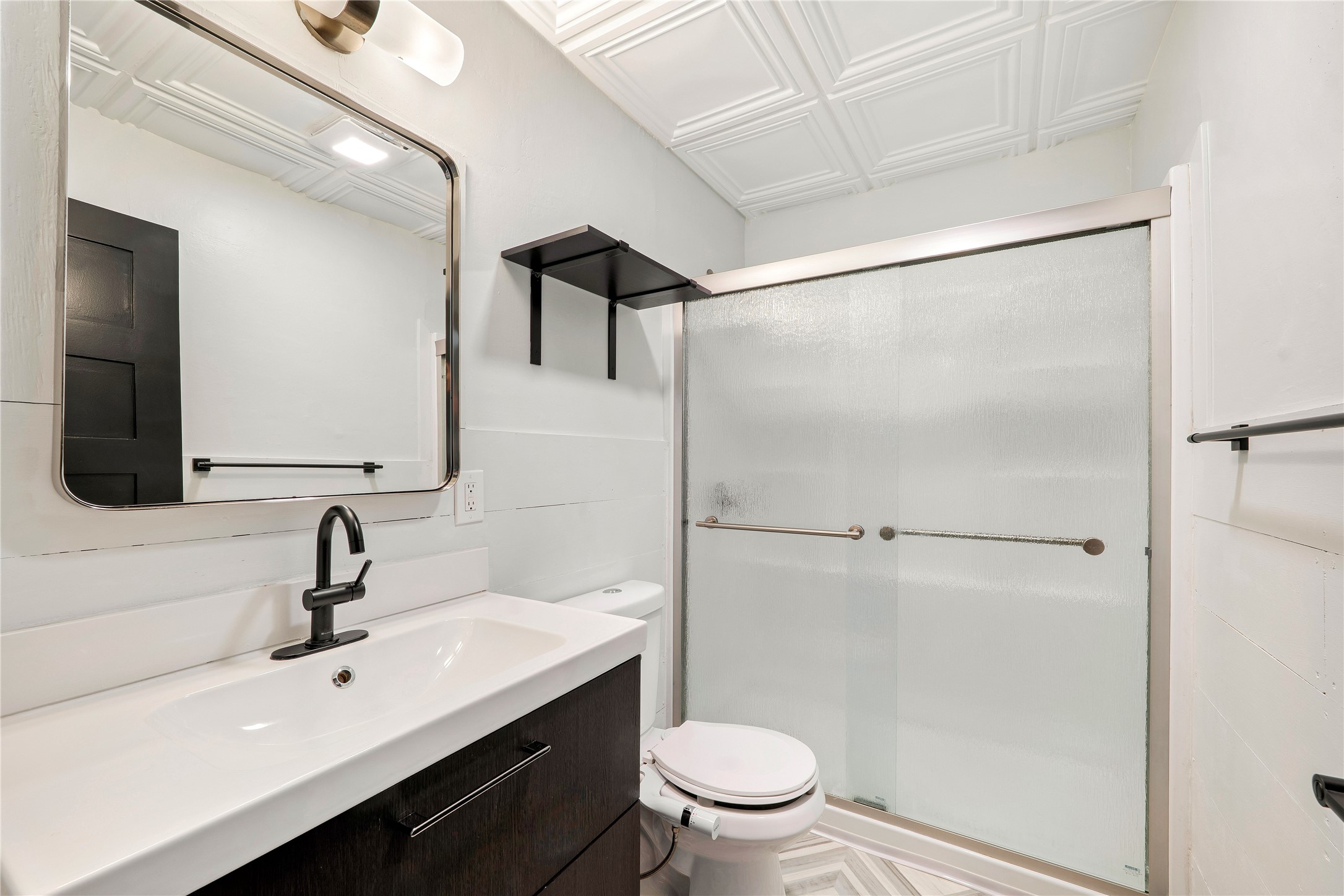 6915 Providence Avenue Austin, TX 78752 - Photo 16 of 27 a bathroom with a sink toilet and shower