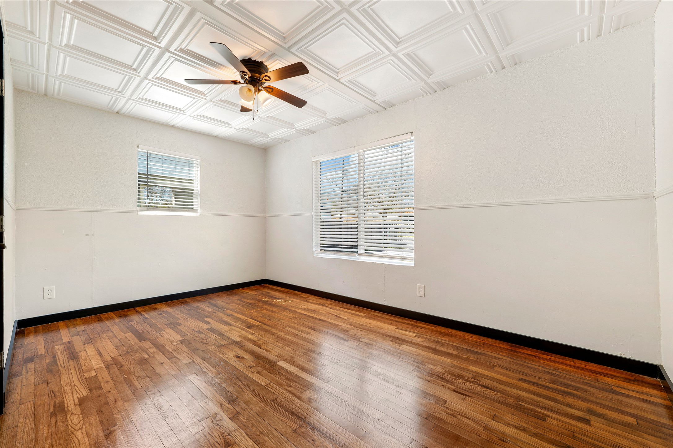 6915 Providence Avenue Austin, TX 78752 - Photo 18 of 27 an empty room with wooden floor fan and windows