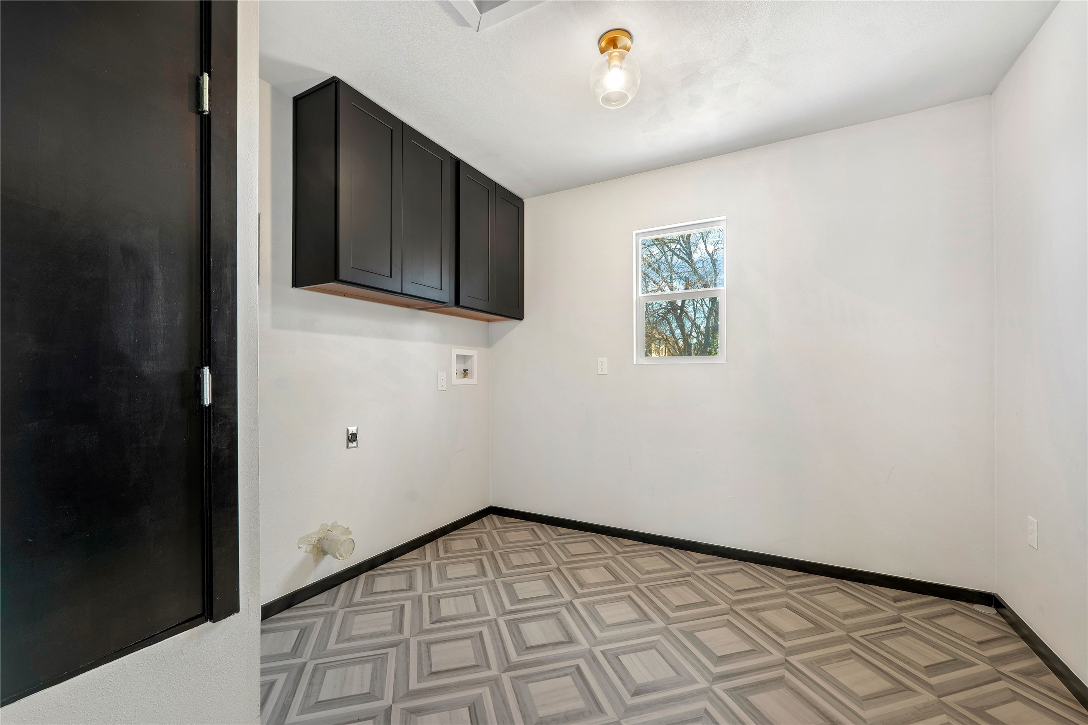 6915 Providence Avenue Austin, TX 78752 - Photo 20 of 27 a view of an empty room with wooden floor and a window