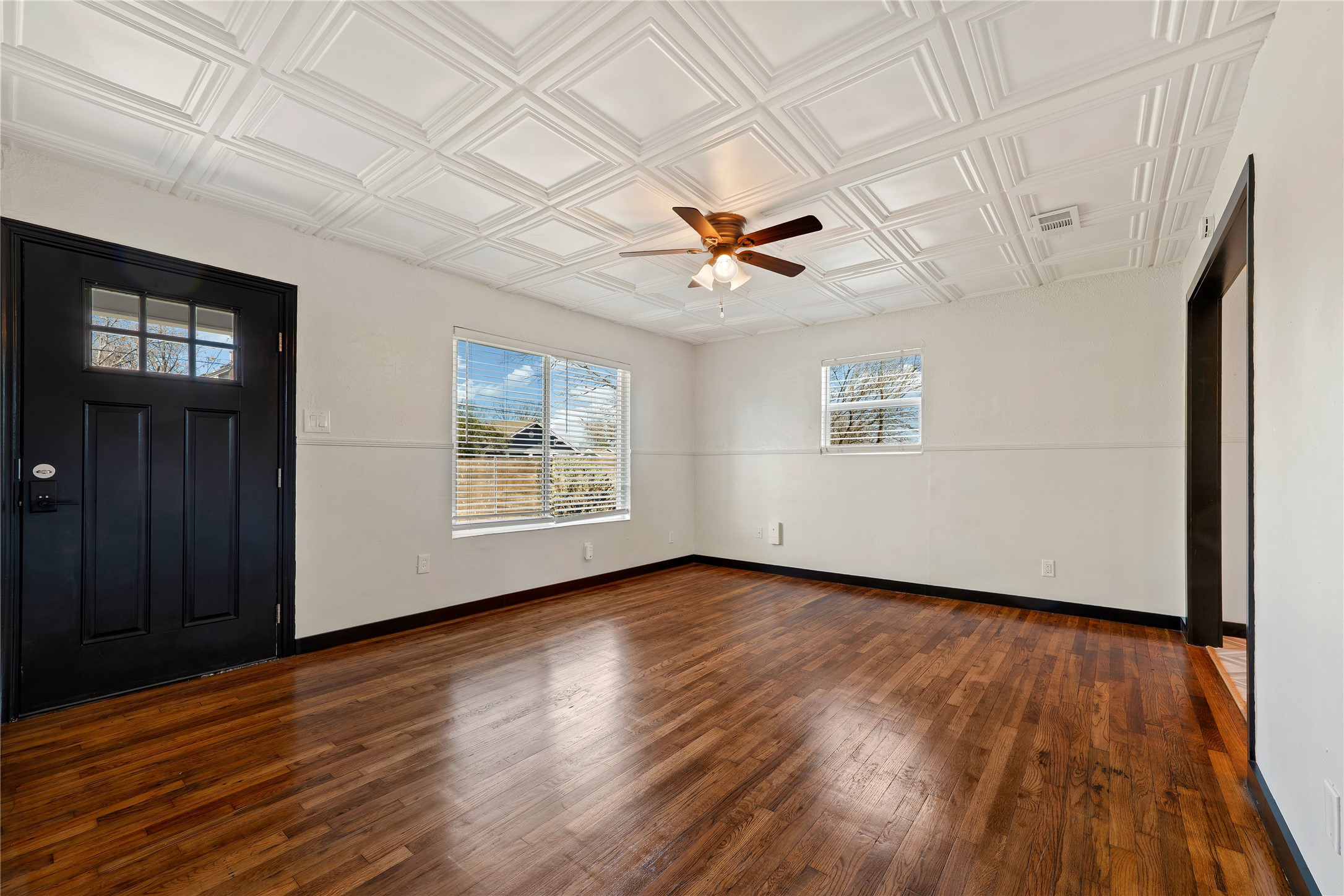 6915 Providence Avenue Austin, TX 78752 - Photo 8 of 27 wooden floor in an empty room with a window