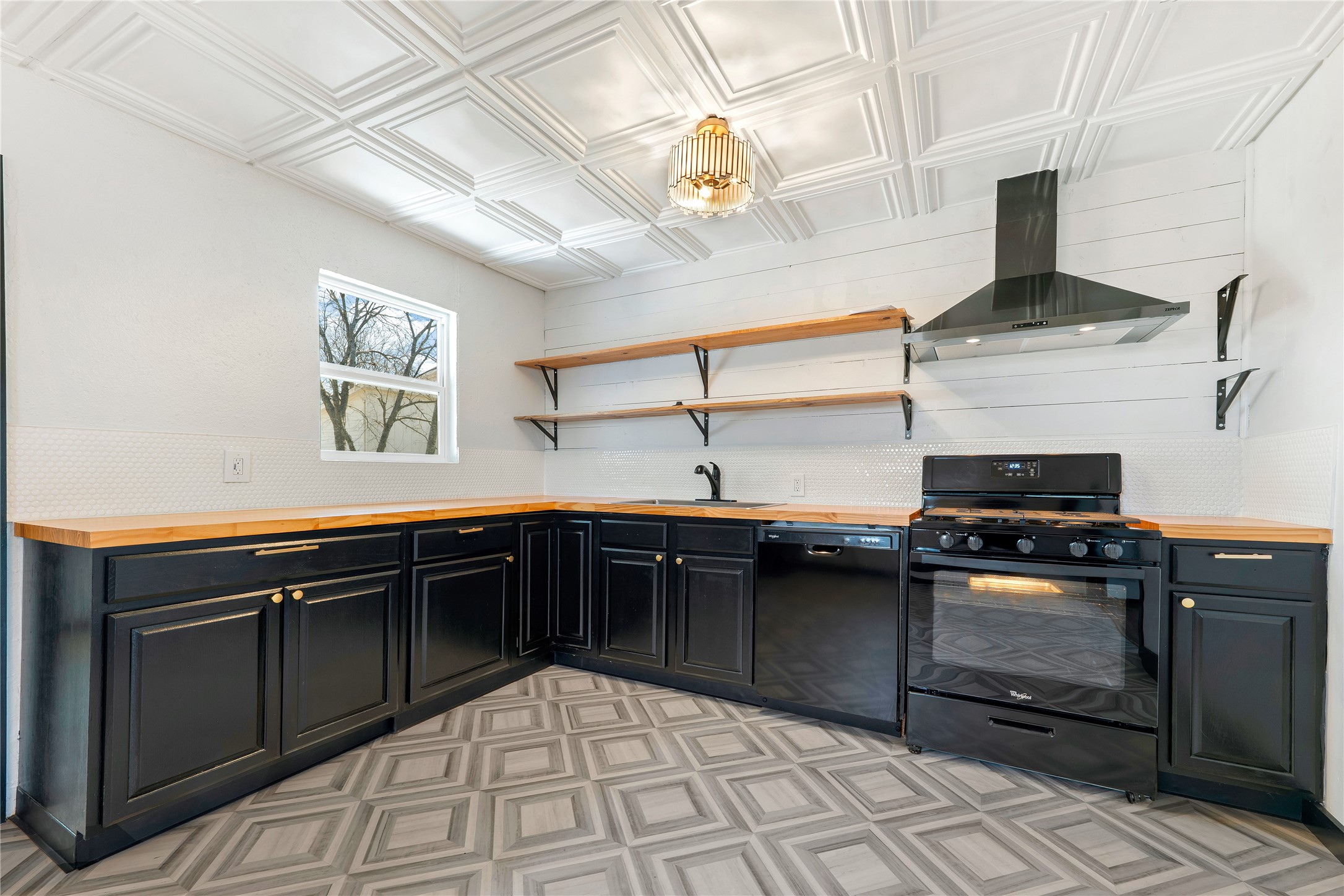 6915 Providence Avenue Austin, TX 78752 - Photo 9 of 27 a kitchen with a sink stove and cabinets