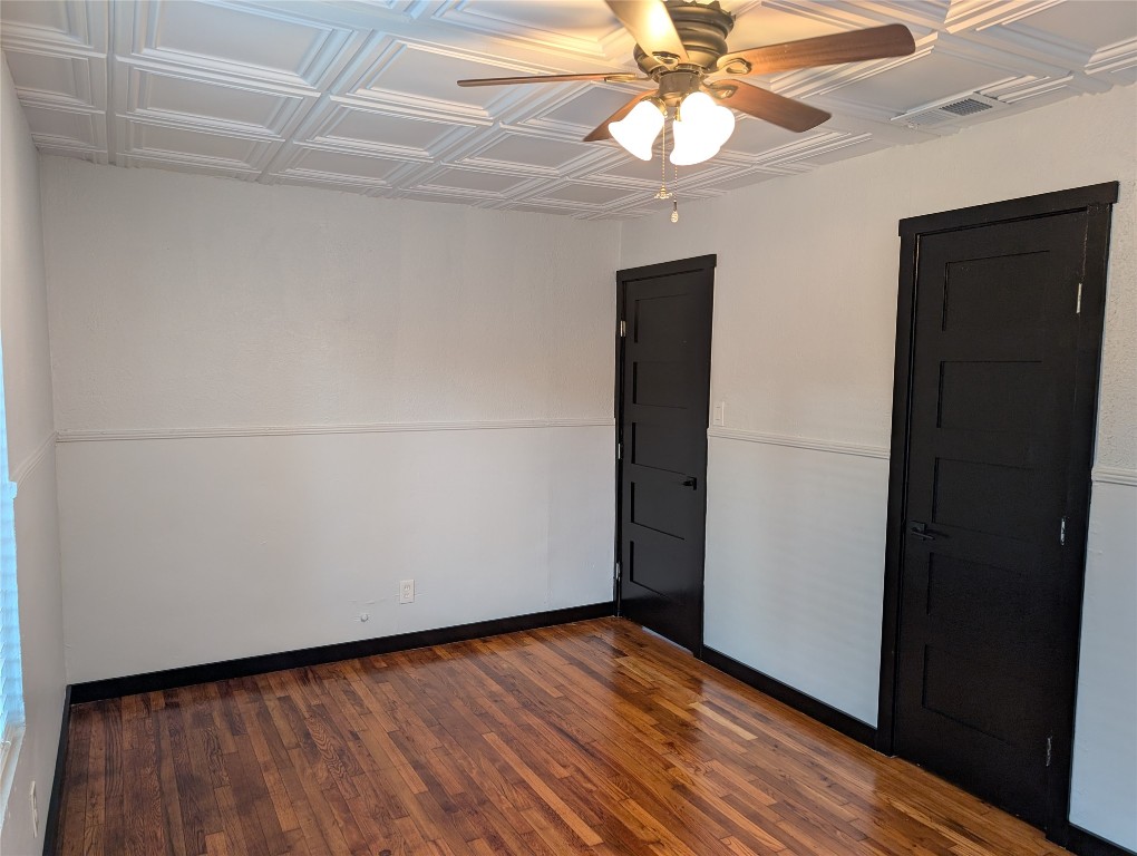 6915 Providence Avenue Austin, TX 78752 - Photo 10 of 27 Primary bedroom featuring a ceiling and hard wood flooring
