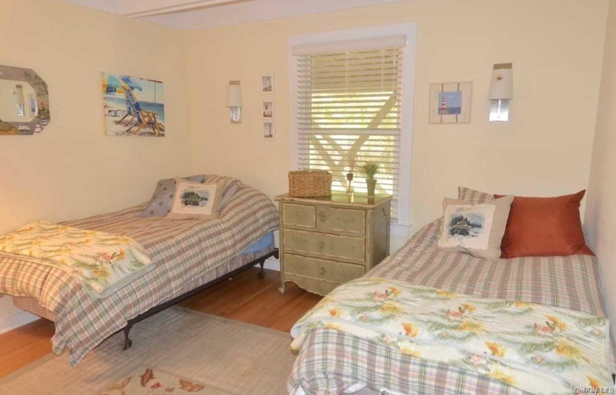 207 Wilmot Road Ocean Beach, NY 11770 - Photo 15 of 24 a bedroom with a bed and a window