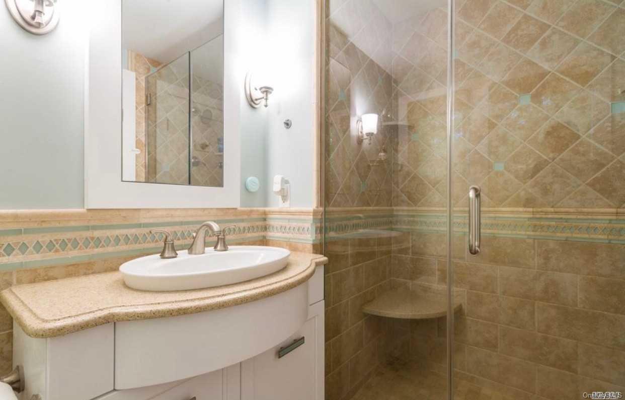 207 Wilmot Road Ocean Beach, NY 11770 - Photo 16 of 24 a bathroom with a sink shower and a mirror