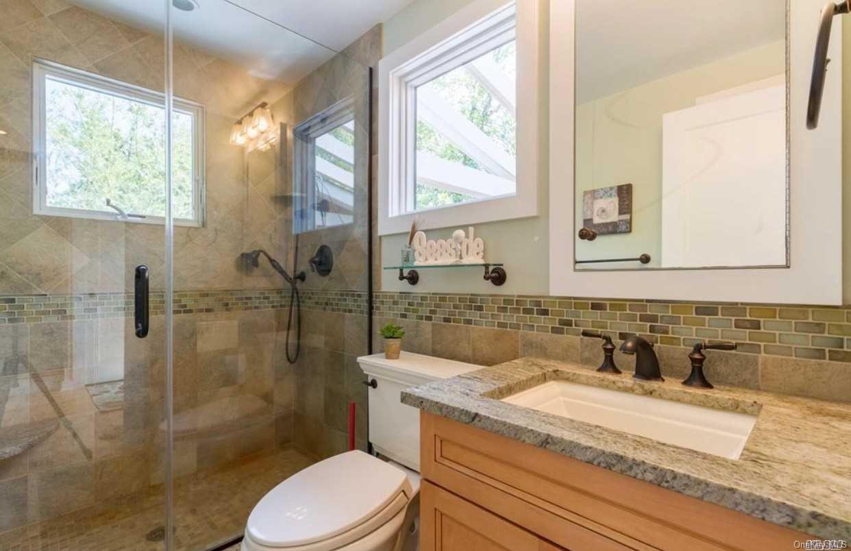 207 Wilmot Road Ocean Beach, NY 11770 - Photo 18 of 24 a bathroom with a sink toilet and shower
