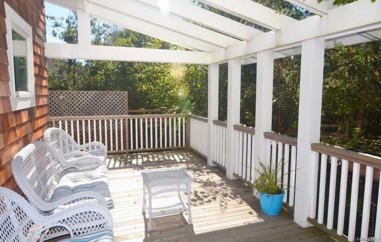 207 Wilmot Road Ocean Beach, NY 11770 - Photo 2 of 24 a view of a two chairs in the porch