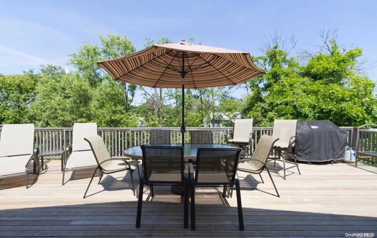 207 Wilmot Road Ocean Beach, NY 11770 - Photo 23 of 24 a view of a chairs and table on the wooden floor