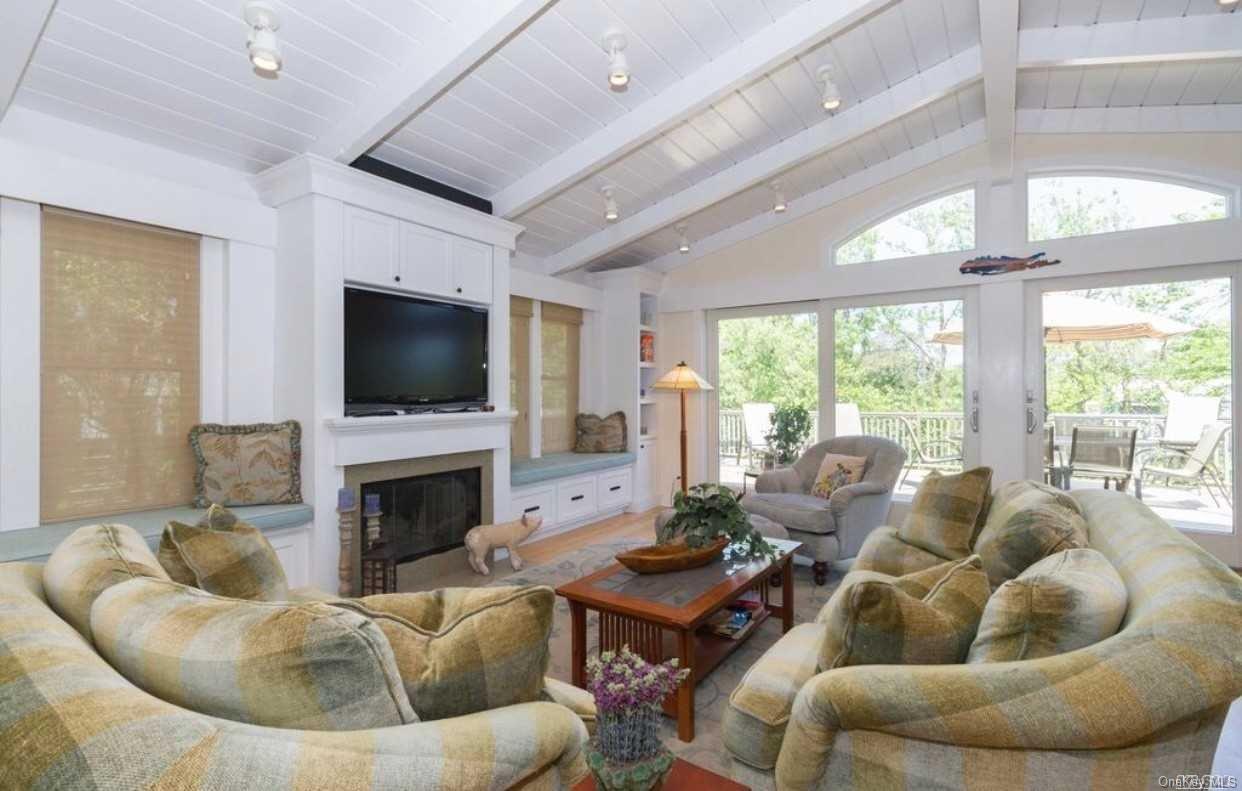 207 Wilmot Road Ocean Beach, NY 11770 - Photo 6 of 24 a living room with furniture fireplace and a flat screen tv
