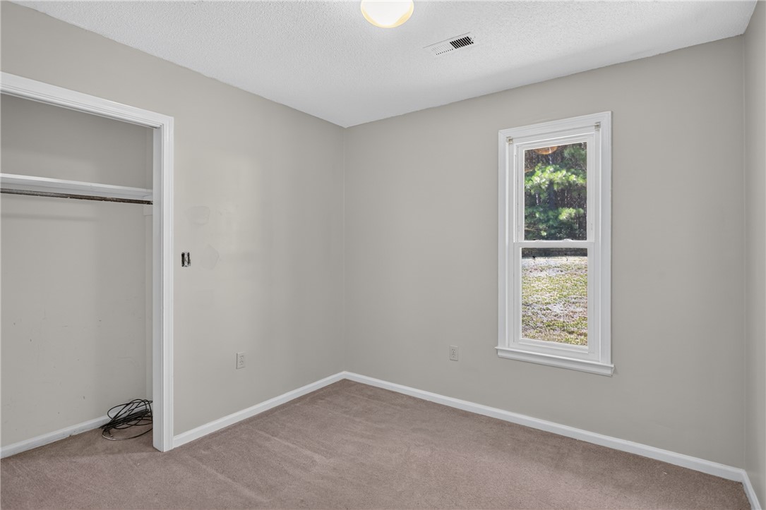 1412 Simpson Road Pendleton, SC 29670 - Photo 25 of 48 A well-lit bedroom provides comfortable living space with a closet for storage.