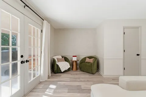 a view of a hallway with wooden floor and staircase