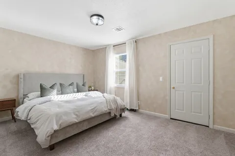 a bedroom with a bed and a table