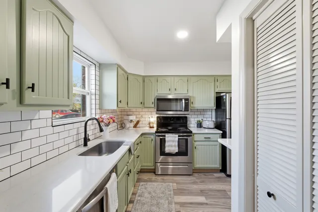 a kitchen with a sink stove and microwave