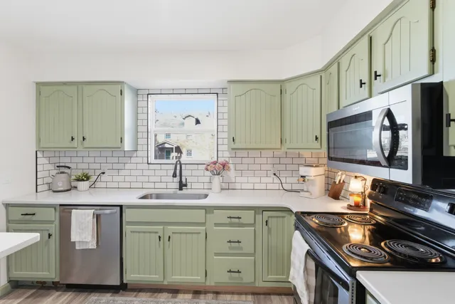 a view of a hallway to a livingroom with furniture and wooden floor