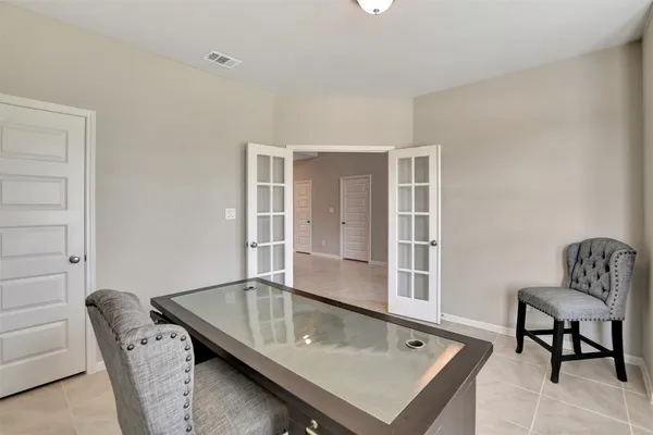 a living room with furniture pool table and chair