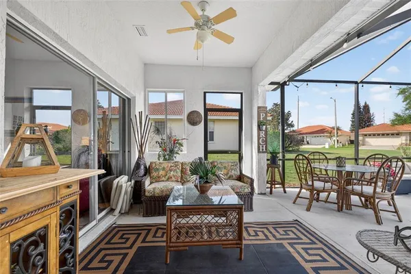 a view of a patio with dining table and chairs under an umbrella