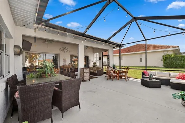 a view of a patio with a table chairs and a backyard