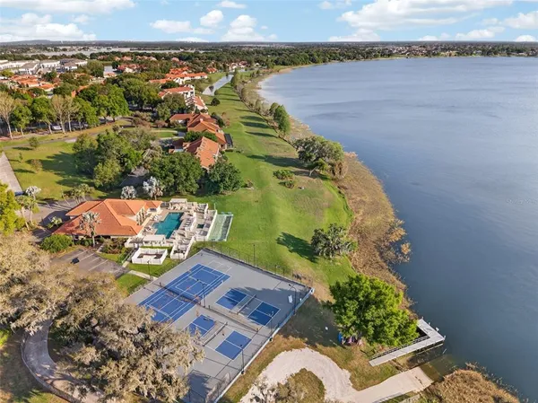 a view of a lake with lawn chairs