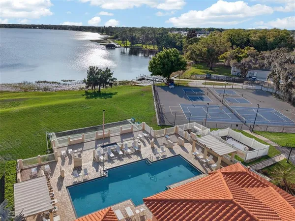 an aerial view of a house with a swimming pool yard and lake view