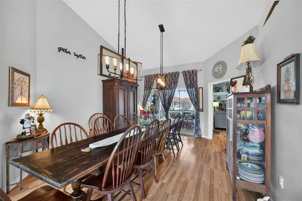 a view of a dining room with furniture and wooden floor