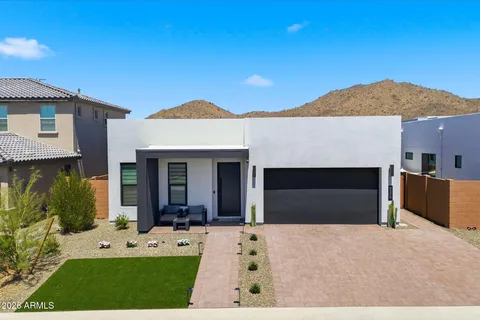a view of a house with a yard and garage