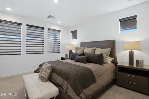 a living room with stainless steel appliances granite countertop a sink dishwasher and a flat screen tv with wooden floor