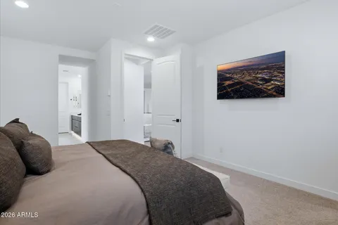 a bedroom with a bed and a lamp