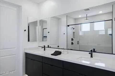 a bathroom with 2 sink and a mirror
