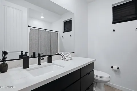 a large bed sitting in a bedroom next to a window