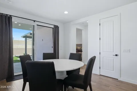 a large kitchen with stainless steel appliances kitchen island granite countertop a sink and a refrigerator