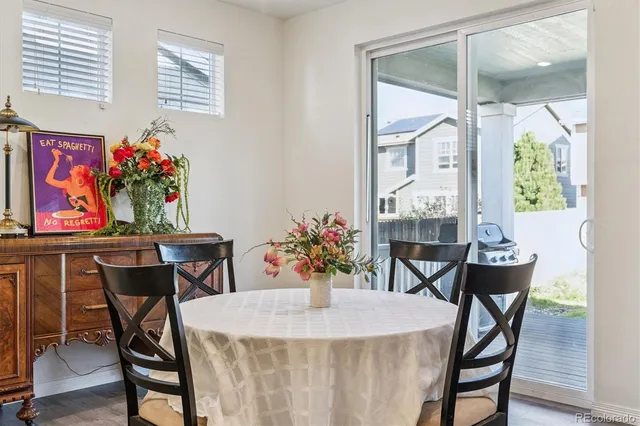 a view of a dining room with furniture and a potted plant