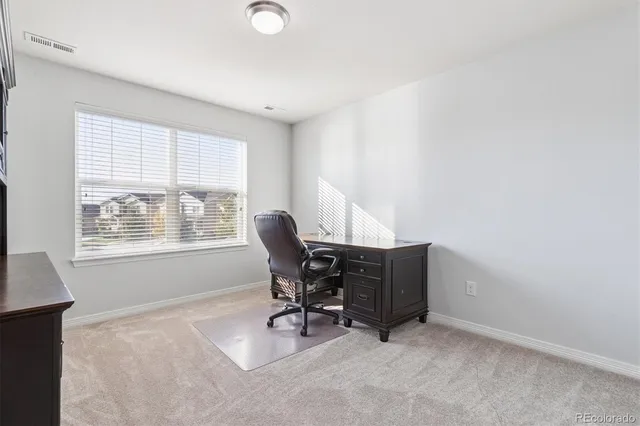 a workspace with furniture and a window