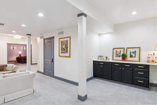 a en suite bathroom with a granite countertop sink and a mirror