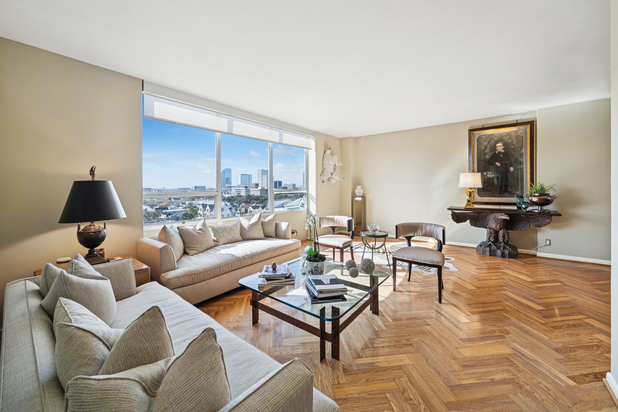 Living area featuring elegant herringbone wood floors, creating a warm and inviting space.
