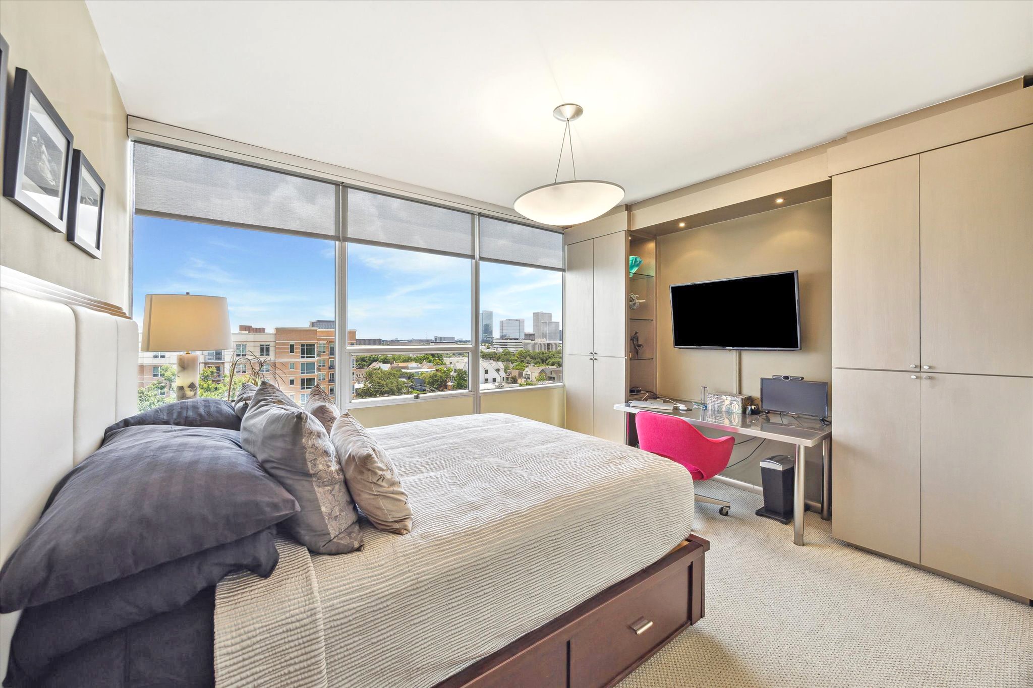 2701 Westheimer Road, Unit 9E Houston, TX 77098 - Photo 16 of 31 The secondary bedroom is a comfortable and functional space, thoughtfully integrated built-in storage solutions that provide ample organization. There is also space for a desk, and the windows are equipped with convenient solar shades for adjustable natural light control.