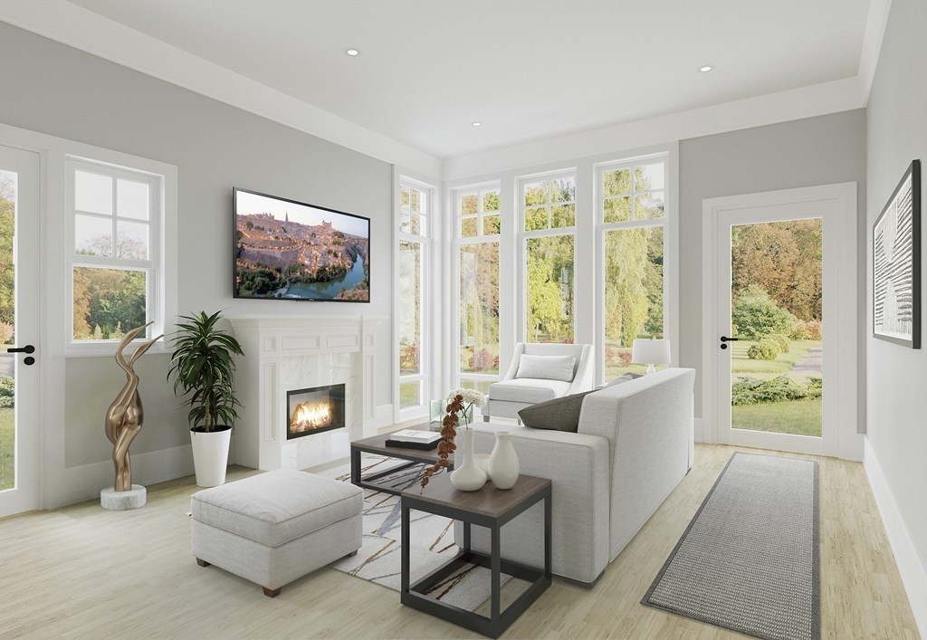 163 Atlantic Road, Unit 1 Gloucester, MA 01930 - Photo 5 of 16 a living room with furniture a flat screen tv and a fireplace