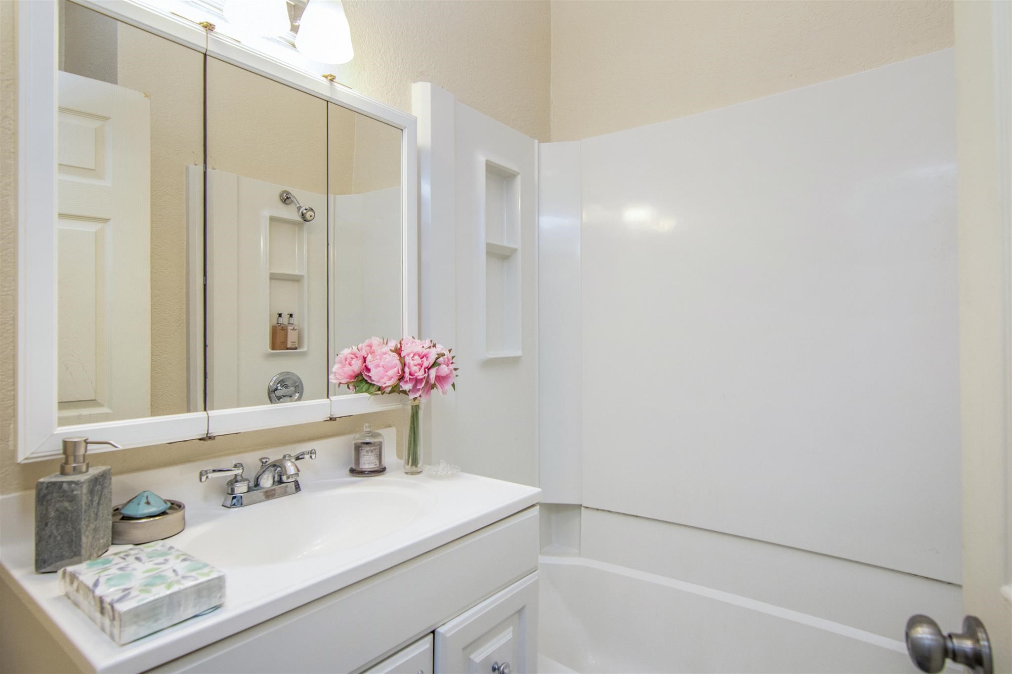11844 13th Street Santa Fe, TX 77510 - Photo 11 of 17 a bathroom with a sink and a mirror